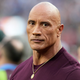 Dwayne “The Rock” Johnson stands on the field before the NFL Super Bowl 56 football game between the Los Angeles Rams and the Cincinnati Bengals, Sunday, Feb. 13, 2022, in Inglewood, Calif.